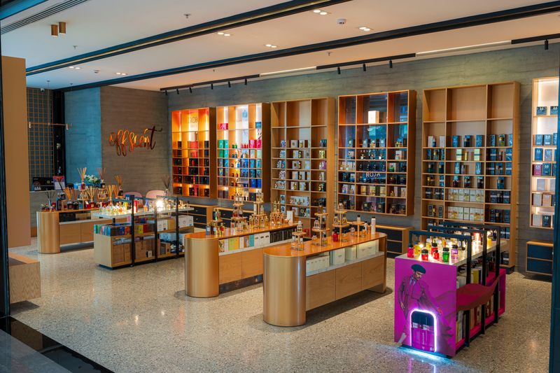 Inside the Offscent boutique at Family Mall, Erbil: lit wall units and fragrance tables